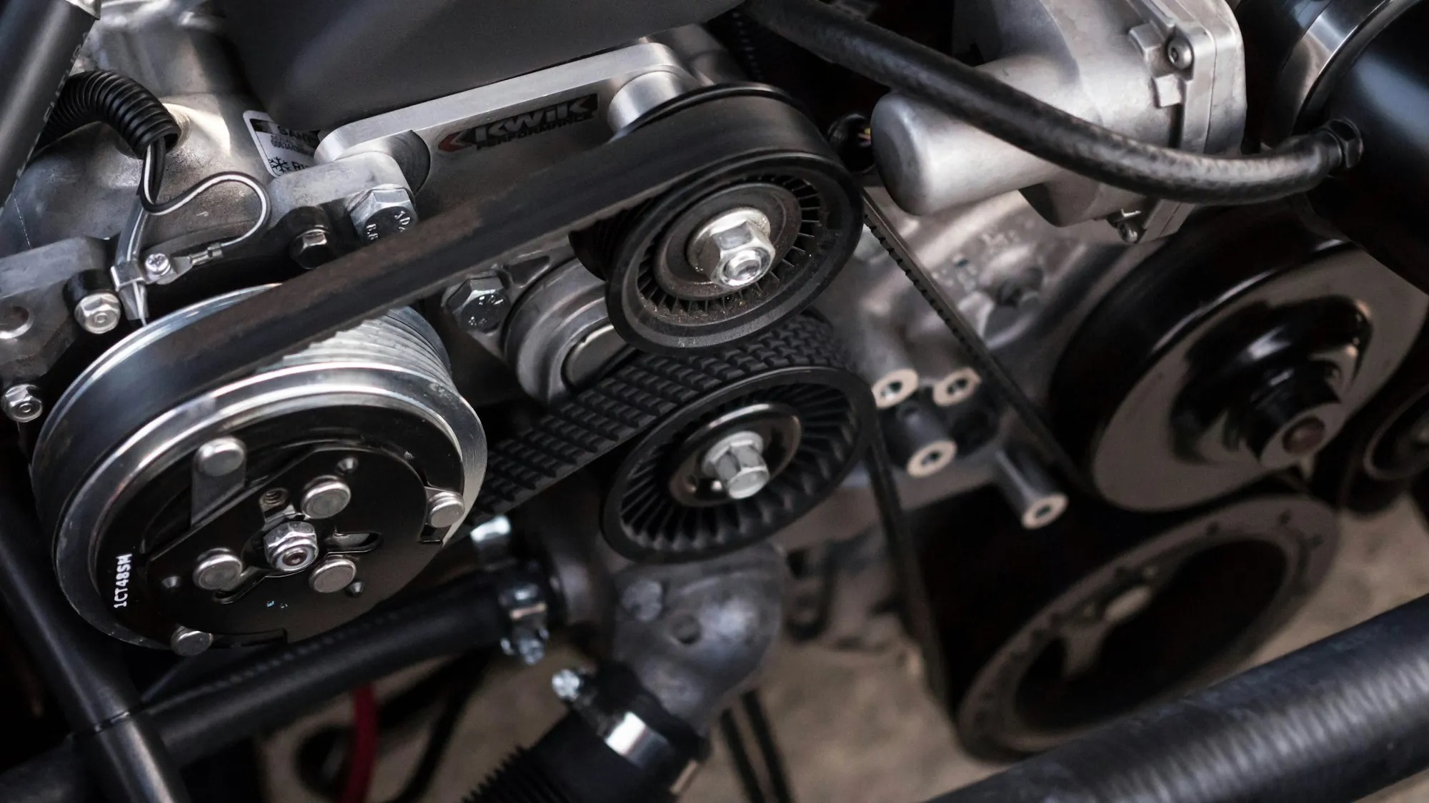 Engine belt drive with pulleys and tensioners
